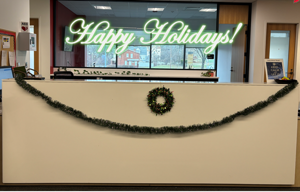 Happy Holidays: Circulation Desk with a wreath and draped with garland